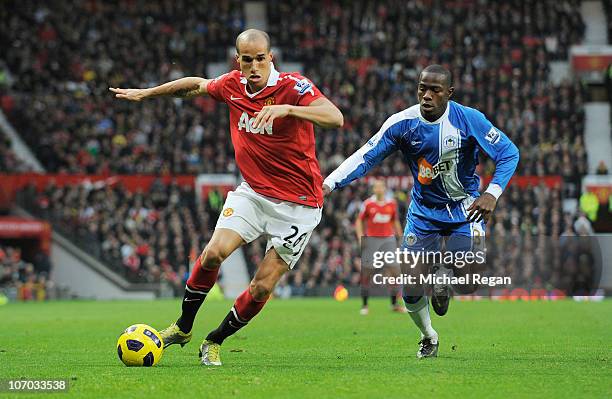 Maynor Figueroa of Wigan battles Gabriel Obertan of Manchester United during the Barclays Premier League match between Manchester United and Wigan...