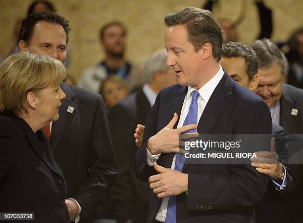 France's President Nicolas Sarkozy chats with United Kingdom's Prime Minister David Cameron and Germany's Chancellor Angela Merkel prior to the NRC...