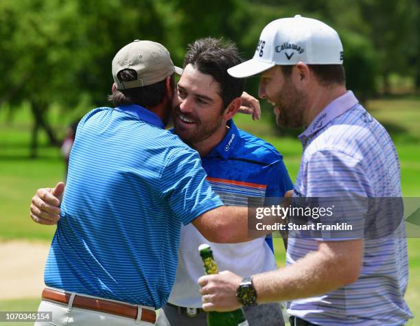 Louis Oosthuizen of South Africa is congratulated by Thomas Aiken of South Africa and Branden Grace of South Africa after victory in the final round...