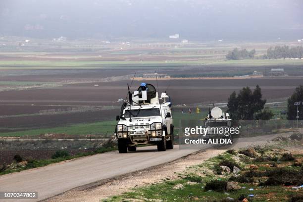 United Nations Interim Force in Lebanon vehicle patrols along the border with Israel near the southern Lebanese city of Marjayoun, with the plain of...