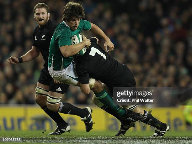 Donncha O' Callaghan of Ireland is tackled by Richie McCaw of the All Blacks during the Test match between Ireland and the New Zealand All Blacks at...