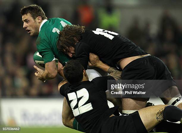 Tommy Bowe of Ireland is tackled by Sonny Bill Williams and Sam Whitelock of the All Blacks during the Test match between Ireland and the New Zealand...