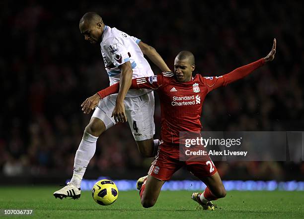 Daniel Gabbidon of West Ham United tangles with David Ngog of Liverpool during the Barclays Premier League match between Liverpool and West Ham...