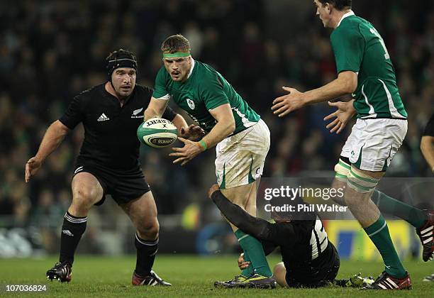 Jamie Heaslip of Ireland is tackled by Mils Muliaina of the All Blacks during the Test match between Ireland and the New Zealand All Blacks at Aviva...