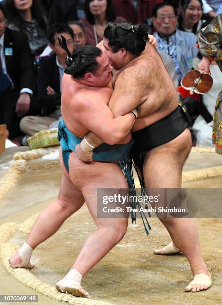 Ozeki Takayasu pushes Mongolian wrestler Tamawashi out of the ring to win on day six of the Grand Sumo Kyushu Tournament at Fukuoka Convention Center...