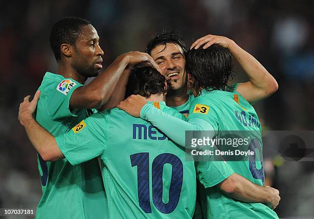 Lionel Messi of Barcelona celebrates with David Villa and Seydou Keita after scoring a goal during the La Liga match between UD Almeria and Barcelona...