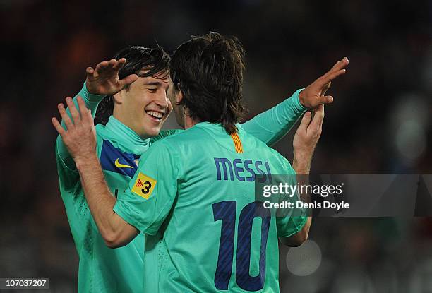 Bojan Krkic of Barcelona celebrates with Lionel Messi after scoring a goal during the La Liga match between UD Almeria and Barcelona at Estadio del...