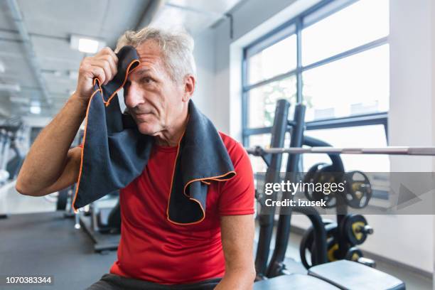 senior man resting at the rehab gym - rubbing stock pictures, royalty-free photos & images