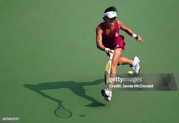 Kimiko Date-Krumm of Japan plays a backhand in the Women's seli-final match against Shuai Peng of China at the Aoti Tennis Centre during day nine of...