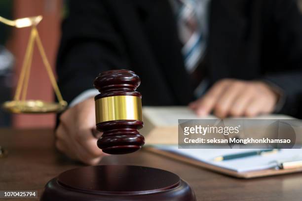 judge with gavel on table. attorney, court judge,tribunal and justice concept. - legal defense stock pictures, royalty-free photos & images