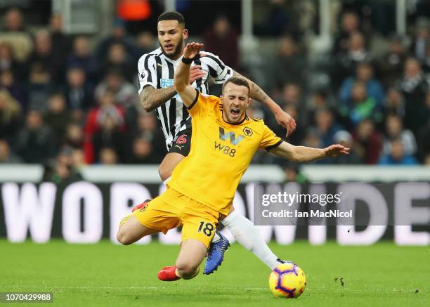 Diogo Jota of Wolverhampton Wanderers is challenged by Jamaal Lascelles of Newcastle United during the Premier League match between Newcastle United...