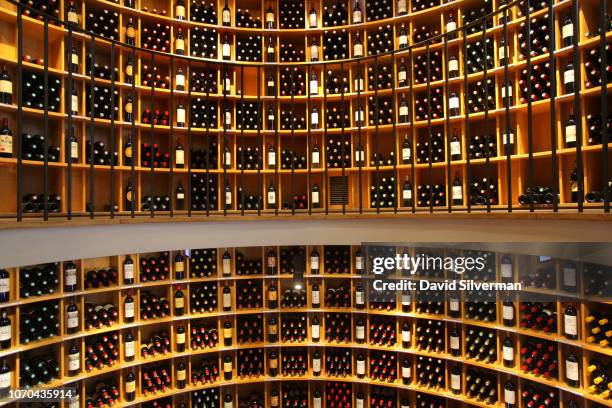 Bordeaux wines cover the shelves at the L'Intendant Grands Vins de Bordeaux wine shop on June 29, 2018 in Bordeaux, France. L'Intendant is considered...