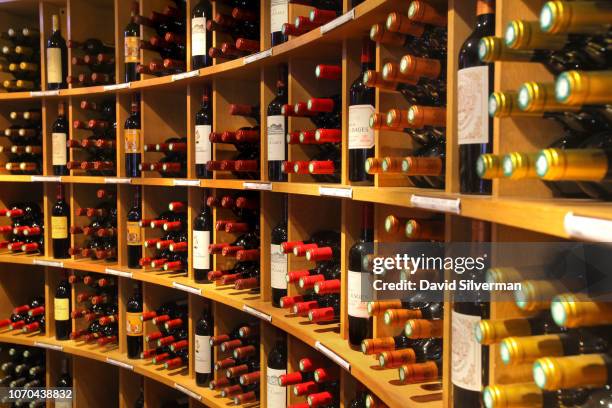 Bordeaux wines cover the shelves at the L'Intendant Grands Vins de Bordeaux wine shop on June 29, 2018 in Bordeaux, France. L'Intendant is considered...