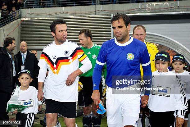 Lothar Matthaeus of the World Champion 1990 and Ulf Kirsten of the DFV Legend enter the pitch before the Reunification match between the World...