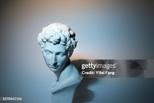 Head sculpture in front of colorful background Head sculpture in front of colorful background