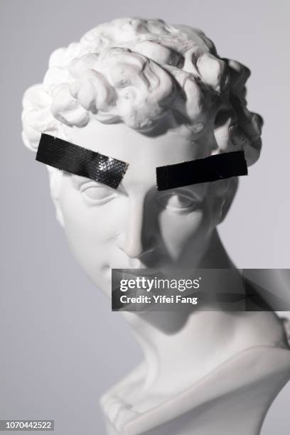 head sculpture with tape over eyebrows - bust sculpture stock pictures, royalty-free photos & images