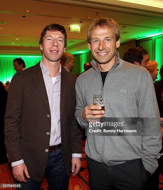 Head coach Steffen Freund of U17 Team Germany and Juergen Klinsmann of the World Champion 1990 pose during the Players Night at the Westin Hotel on...