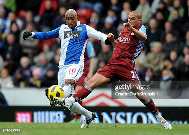 El Hadji Diouf of Blackburn Rovers is challenged by Luke Young of Aston Villa during the Barclays Premier League match between Blackburn Rovers and...