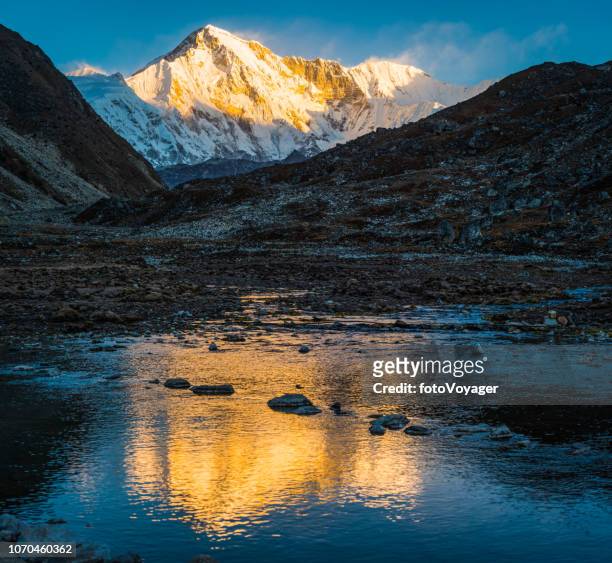 cho oyu 8188m golden sunrise snow summit lake reflection himalayas nepal - himalayas sunrise stock pictures, royalty-free photos & images