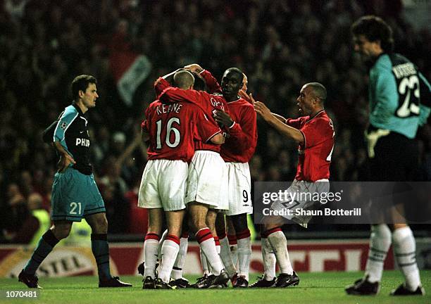 Dwight Yorke of Man Utd celebrates with team-mates after scoring the third goal during the Manchester United v PSV Eindhoven UEFA Champions League...