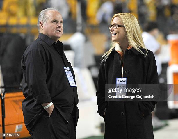 Radio talk show host and political commentator Rush Limbaugh and his wife, Kathryn Rogers, look on from the sideline before a National Football...