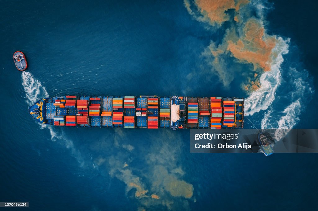 Aerial view of cargo ship, cargo container in warehouse harbor.