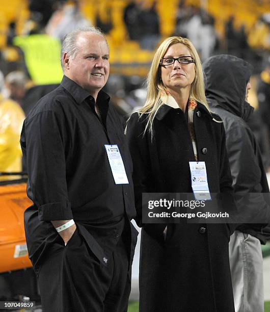 Radio talk show host and political commentator Rush Limbaugh and his wife, Kathryn Rogers, look on from the sideline before a National Football...