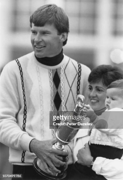 Nick Faldo of England holds The Claret Jug Gill Faldo and son Matthew after his victory during the final round in the 116th Open Championship played...