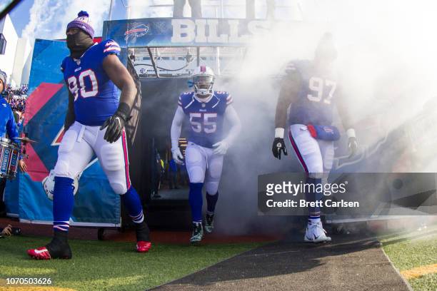 Shaq Lawson, Jerry Hughes and Jordan Phillips of the Buffalo Bills walk out of the tunnel before the game against the New York Jets at New Era Field...