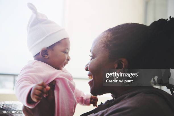 african grandmother and baby granddaughter intimate time side view - african american grandmother stock pictures, royalty-free photos & images