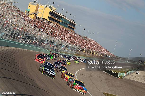 Kyle Busch, driver of the M&M'sToyota, and Carl Edwards, driver of the Aflac Ford, lead a group of cars during the NASCAR Sprint Cup Series Ford 400...