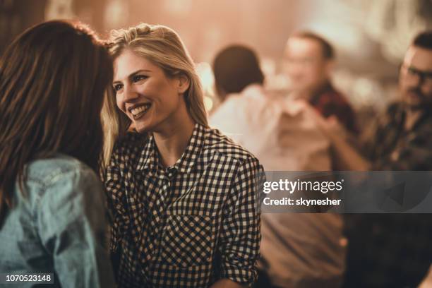 feliz mulher lésbica, flertando com a amiga em um pub. - lesbian date - fotografias e filmes do acervo