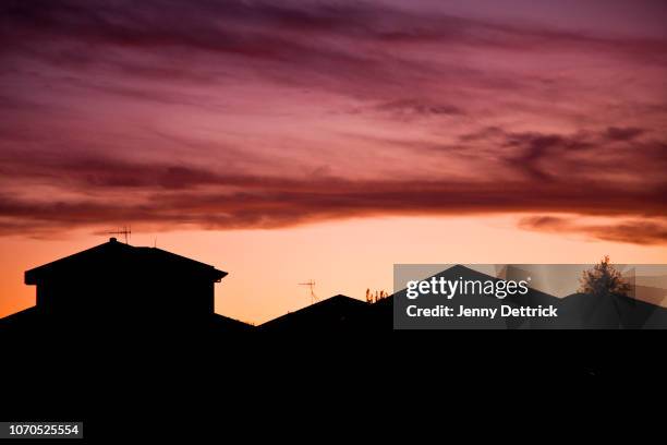 silhouette of houses at sunset - suburb stock pictures, royalty-free photos & images