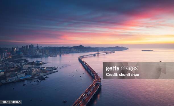 sea crossing bridge - cityscape sunrise stock pictures, royalty-free photos & images