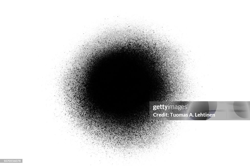 Close-up of a black spray paint spot, isolated on white background.