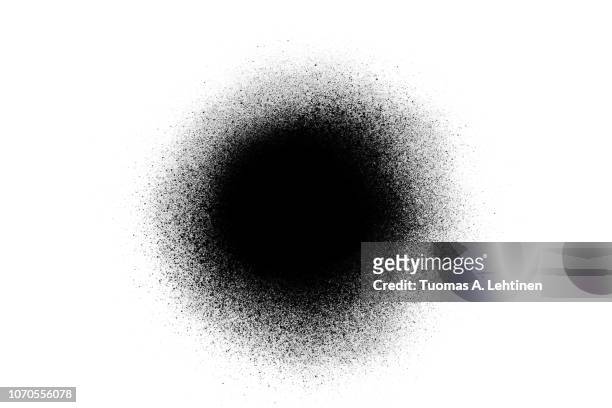 close-up of a black spray paint spot, isolated on white background. - spray paint stock pictures, royalty-free photos & images