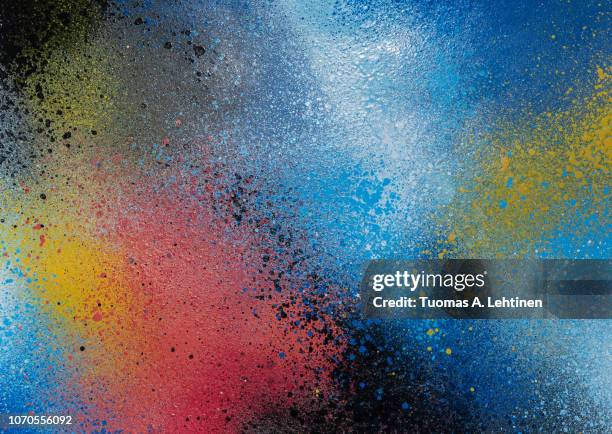 full frame photo of a colorful and splattered spray paint background. - graffiti wand stock-fotos und bilder