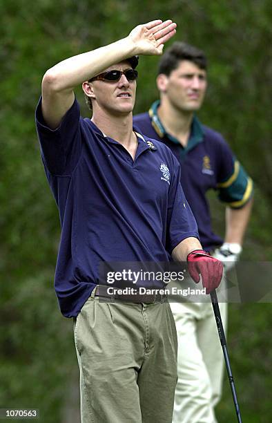 Chris Fydler who won a Gold Medal in Swimming at the 2000 Sydney Olympics watches his ball go in to the rough as John Eales of the Australian...