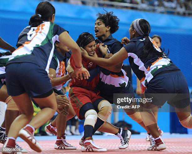 Farzana Akhtar Baby of Bangladesh is held by Henry Joseph Deepika of India during their women's kabaddi group B round 1 match at the 16th Asian Games...