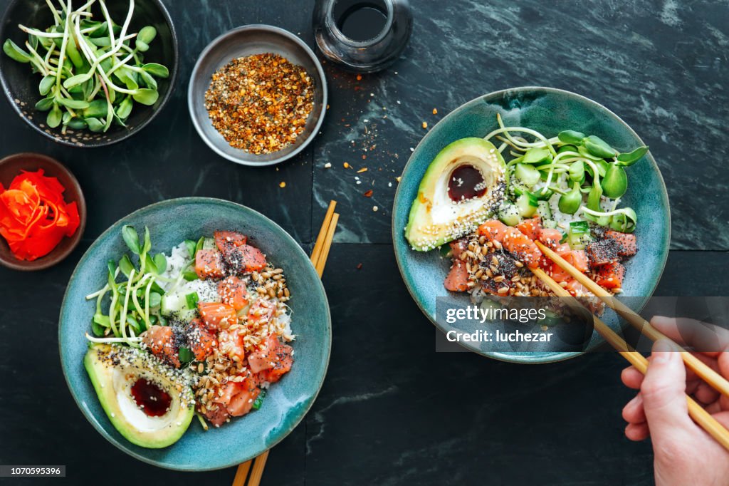 Man eating poke bowls with ponzu dressing