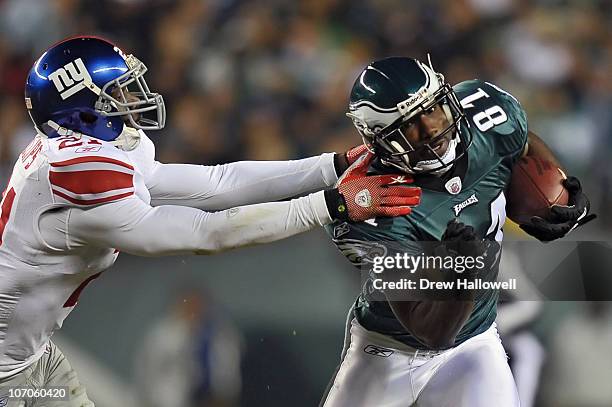 Wide Receiver Jason Avant of the Philadelphia Eagles tries to avoid safety Kenny Phillips of the New York Giants at Lincoln Financial Field on...