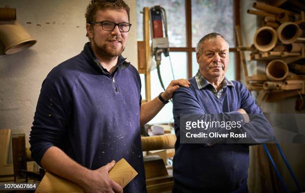 old and young instrument maker in workshop with alpenhorn instrument parts - melody maker fotografías e imágenes de stock