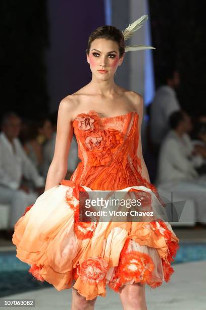 Model walks the runway at the Victorio & Lucchino Spring/Summer 2011 during the Cancun Moda Nextel 2010 fashion show at Le Blanc Spa Resort on...