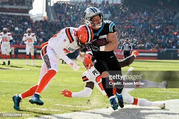 Christian McCaffrey of the Carolina Panthers is pushed out of bounds by Damarious Randall of the Cleveland Browns during the first quarter at...