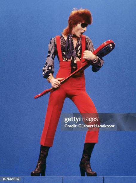 Full length portrait of David Bowie performing on the Dutch TV show TopPop playing the song 'Rebel Rebel' and wearing an eye patch on 7th February...