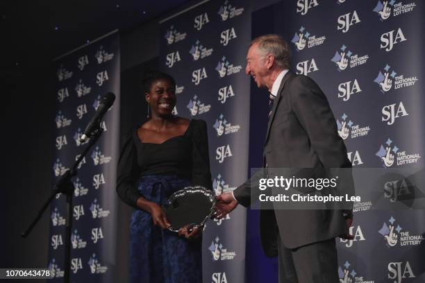 Christine Ohuruogu is presented with her National Lottery Spirit of Sport Award by David Hemery during The SJA British Sports Awards 2018 at Tower of...