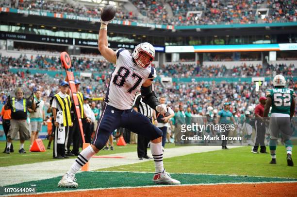 Rob Gronkowski of the New England Patriots celebrates his touchdown in the second quarter against the Miami Dolphins at Hard Rock Stadium on December...