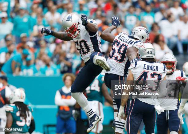 Albert McClellan and Ramon Humber of the New England Patriots celebrate after blocking the punt during the second quarter against the Miami Dolphins...