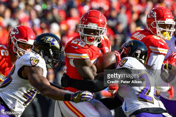Damien Williams of the Kansas City Chiefs fights for extra yardage on a rush during the second quarter of the game against the Baltimore Ravens at...