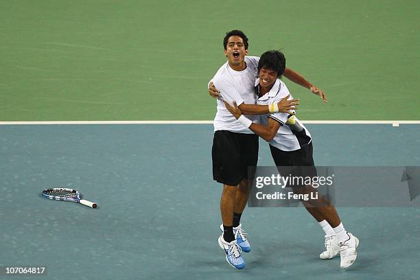 Devvarman Sk and Sanam Krishan Singh of India celebrate winning the gold medal of the Men's Doubles Final tennis match at Aoti Tennis Centre during...